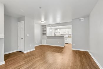 living room and kitchen with wood flooring  at The Buttes Apartments Loveland, CO